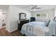 Bright bedroom with nautical bedding, wood floors, ceiling fan, and television at 5416 Swift Rd # 27, Sarasota, FL 34231