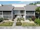 Inviting condo with screened patios, lush landscaping, and a walkway leading to the entrance at 5416 Swift Rd # 27, Sarasota, FL 34231