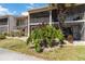 Two-story condo building featuring mature trees and lush landscaping at 5416 Swift Rd # 27, Sarasota, FL 34231