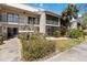 Two-story condo building featuring lush landscaping, screened-in lanais, and a well-maintained exterior at 5416 Swift Rd # 27, Sarasota, FL 34231