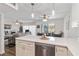 Modern kitchen boasts white cabinets, stainless steel appliances, and a breakfast bar with pendant lighting at 5416 Swift Rd # 27, Sarasota, FL 34231