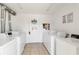 Bright laundry room featuring multiple washing machines and tiled flooring for easy maintenance at 5416 Swift Rd # 27, Sarasota, FL 34231
