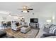 Open living room featuring ceiling fan, wood floors, neutral paint and a dining area in the background at 5416 Swift Rd # 27, Sarasota, FL 34231