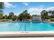 Sparkling community pool with lounge chairs and lush tropical landscaping, perfect for relaxation at 5416 Swift Rd # 27, Sarasota, FL 34231
