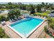 A sparkling pool with lounge chairs, a small cabana and tropical landscaping are showcased at 5416 Swift Rd # 27, Sarasota, FL 34231