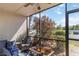 Screened porch with wicker furniture, cushions, and outdoor view at 5416 Swift Rd # 27, Sarasota, FL 34231