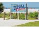 Sign showing Siesta Beach, with sand, sky and people in the background at 5416 Swift Rd # 27, Sarasota, FL 34231