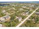An aerial view shows the home in a lush community near waterways at 6329 David Blvd, Port Charlotte, FL 33981