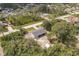 An aerial view shows the home nestled in a wooded community near waterways at 6329 David Blvd, Port Charlotte, FL 33981