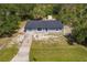 An aerial view of the charming home with a long driveway and a shed at 6329 David Blvd, Port Charlotte, FL 33981