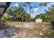Fenced backyard with lush landscaping and a shed at 6329 David Blvd, Port Charlotte, FL 33981