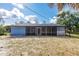 A screened-in porch offers an enjoyable view of the backyard at 6329 David Blvd, Port Charlotte, FL 33981