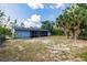 A fenced backyard with palm trees and lush landscaping at 6329 David Blvd, Port Charlotte, FL 33981