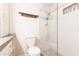 Bathroom featuring white tiling in shower, toilet and wood themed towel rack at 6329 David Blvd, Port Charlotte, FL 33981