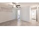 Bedroom showcasing neutral walls, tile floors, a ceiling fan and bathroom access at 6329 David Blvd, Port Charlotte, FL 33981