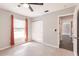 Bedroom featuring neutral walls, tile floors, a ceiling fan, a closet and window with curtains at 6329 David Blvd, Port Charlotte, FL 33981