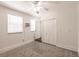 Bright bedroom featuring gray carpet, a ceiling fan, and a double-door closet at 6329 David Blvd, Port Charlotte, FL 33981