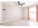 Bedroom featuring neutral walls, tile floors, a ceiling fan, and window with curtains at 6329 David Blvd, Port Charlotte, FL 33981