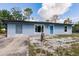 Beautiful single-story home with a well-kept lawn, bright blue door, and charming accents at 6329 David Blvd, Port Charlotte, FL 33981