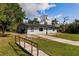Inviting single-story home with a long driveway and a lush green lawn at 6329 David Blvd, Port Charlotte, FL 33981