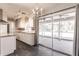 Bright kitchen with white cabinets, modern light fixtures and eat-in space that leads to patio at 6329 David Blvd, Port Charlotte, FL 33981