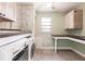 Laundry room with tile floor, washer, dryer, cabinets, counter space, and a window at 6329 David Blvd, Port Charlotte, FL 33981