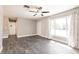 Spacious living room featuring modern flooring, a large window, and neutral wall color at 6329 David Blvd, Port Charlotte, FL 33981