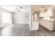 Open-concept living room and kitchen features hardwood flooring, neutral paint, and contemporary fixtures at 6329 David Blvd, Port Charlotte, FL 33981