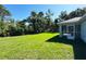 Expansive backyard features a lush green lawn with screened in lanai at 6346 Lachine Ave, North Port, FL 34291