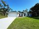 Charming single-Gathering home features a well-manicured lawn and attached two-car garage at 6346 Lachine Ave, North Port, FL 34291
