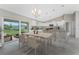 Open floor plan featuring a kitchen with island, stainless steel appliances, and dining area at 6346 Lachine Ave, North Port, FL 34291
