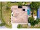 An aerial view of a house with a screen enclosed pool and solar panels in a lush, green environment at 8315 Raoul Ave, North Port, FL 34291