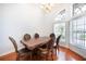 Formal dining room with hardwood floors, chandelier, arched window, and classic furniture at 8315 Raoul Ave, North Port, FL 34291