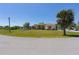 Street view of single-story house featuring arched windows and a manicured lawn at 8315 Raoul Ave, North Port, FL 34291