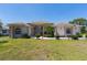 Elegant single Gathering home with landscaped front yard and grand entrance, arched windows, and columns at 8315 Raoul Ave, North Port, FL 34291