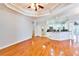Spacious open-plan living area with hardwood flooring and easy access to the kitchen and other rooms at 8315 Raoul Ave, North Port, FL 34291