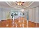 Open concept living room featuring hardwood floors, a ceiling fan, and easy access to the kitchen at 8315 Raoul Ave, North Port, FL 34291