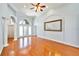 Bright living room featuring hardwood floors, high ceilings, an arched doorway, and neutral paint at 8315 Raoul Ave, North Port, FL 34291