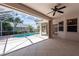 Outdoor patio with ceiling fan featuring a screen enclosure and views of the sparkling pool at 8315 Raoul Ave, North Port, FL 34291