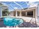 Sparkling pool inside screened-in enclosure features patio area for outdoor relaxation and entertaining at 8315 Raoul Ave, North Port, FL 34291
