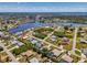 A bird's eye view of a waterfront neighborhood with canals, single-Gathering homes and many homes with pools at 452 Greenwich Nw Ave, Port Charlotte, FL 33952