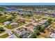 Aerial view of a neighborhood, showing the layout of homes, roads, and surrounding greenery at 452 Greenwich Nw Ave, Port Charlotte, FL 33952