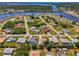 Aerial view of a neighborhood, highlighting the property with a white circle, surrounded by trees and waterways at 452 Greenwich Nw Ave, Port Charlotte, FL 33952