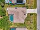 Aerial view of house with pool, lush backyard, and mature landscaping at 452 Greenwich Nw Ave, Port Charlotte, FL 33952