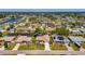 Aerial view of a neighborhood showcasing a single-Gathering home with lush landscaping in a residential area at 452 Greenwich Nw Ave, Port Charlotte, FL 33952