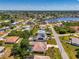 Aerial view of a neighborhood with houses, waterways, and lush landscaping on a sunny day at 452 Greenwich Nw Ave, Port Charlotte, FL 33952