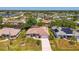 Aerial view showing the house, lush landscaping, and long driveway at 452 Greenwich Nw Ave, Port Charlotte, FL 33952