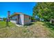 The backyard features a chain link fence, a shed, and some mature trees at 452 Greenwich Nw Ave, Port Charlotte, FL 33952