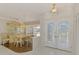 Bright dining area with elegant chandelier, adjacent to the foyer and featuring a beautiful china cabinet at 452 Greenwich Nw Ave, Port Charlotte, FL 33952