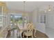 Elegant dining area featuring a chandelier, bay window, and a stylish china cabinet, creating a cozy space at 452 Greenwich Nw Ave, Port Charlotte, FL 33952